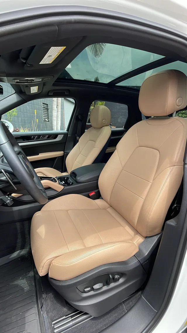 Tan front seats and panoramic glass roof in BLU’s Porsche Cayenne