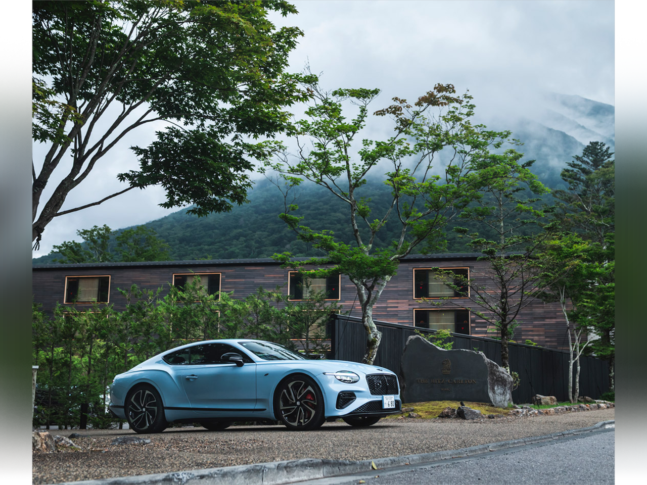 Blue Bentley Continental GT outside a mountain retreat