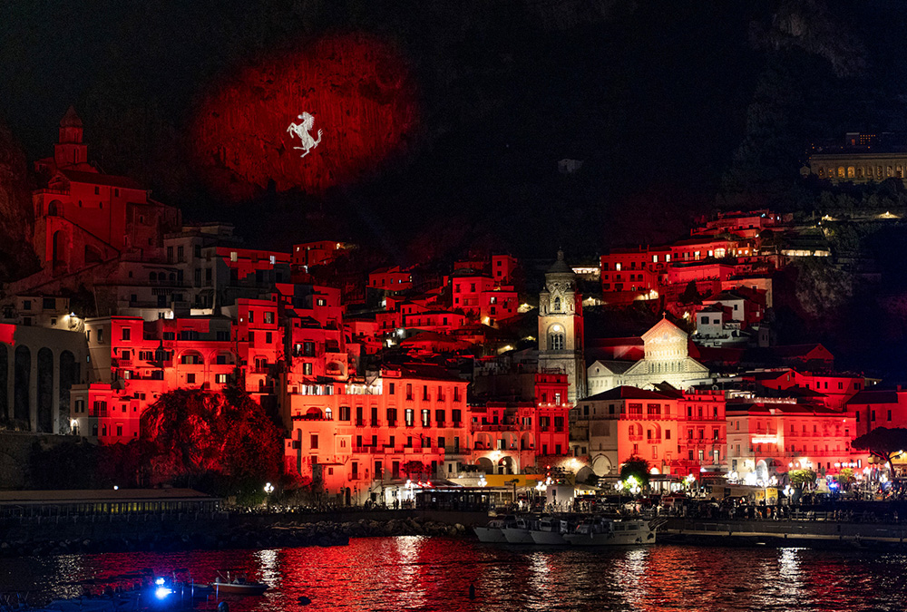 An Italian coastal town illuminated in Ferrari red