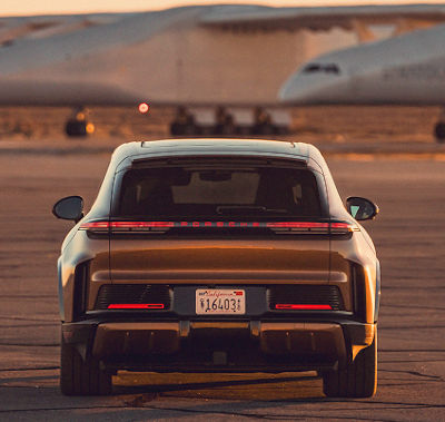A Porsche photographed on an airfield at dusk