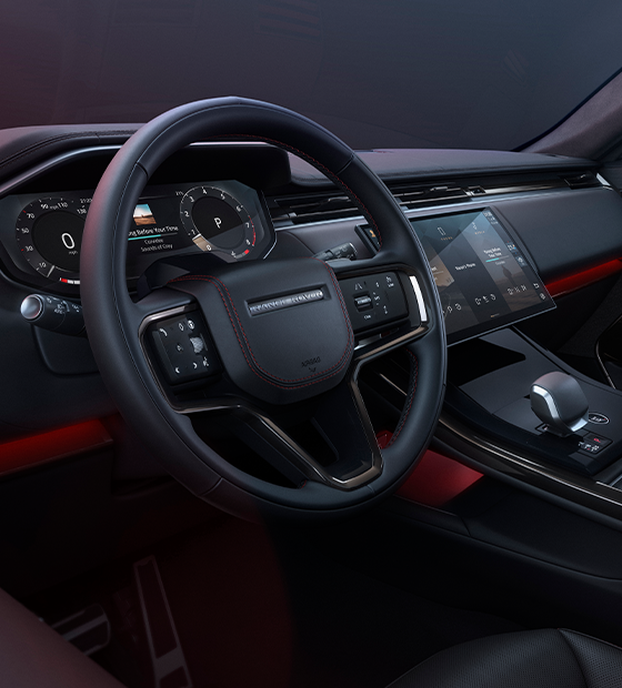 Range Rover cockpit with dark leather and red accents