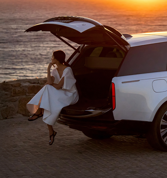 A quiet moment by the sea with a Range Rover at sunset